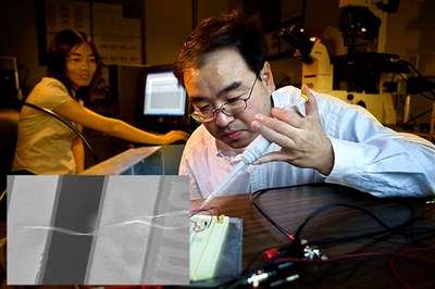 Mechanical engineer Deyu Li in the lab and pair of boron nanoribbons stuck together on a microdevice used to measure thermal conductivity (small image). (Courtesy of the Li Lab & Daniel Dubois/Vanderbilt University)